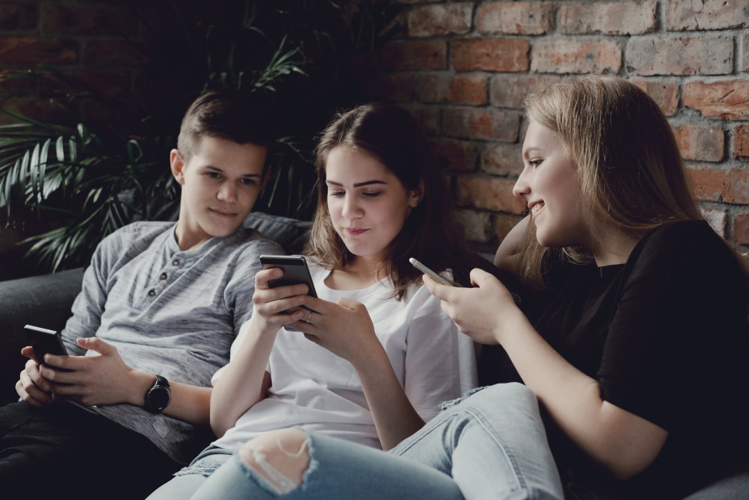 Teenagers using mobile phones